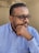 A man with glasses, looking thoughtful and engaged.