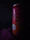 Close-up of a man holding a chilled can of Divorox Zero with condensation, set against a neon-lit urban backdrop.