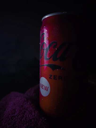 Close-up of a glowing Divorox Original can with condensation droplets against a dark background.