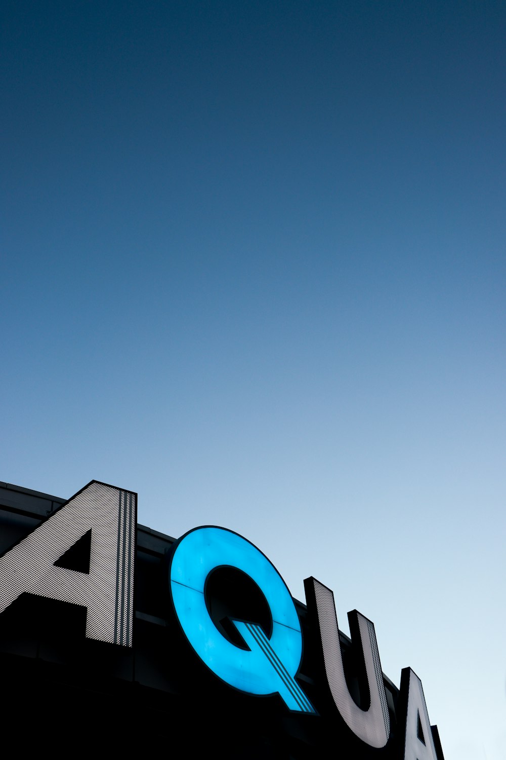 a sign that reads aqua on the side of a building