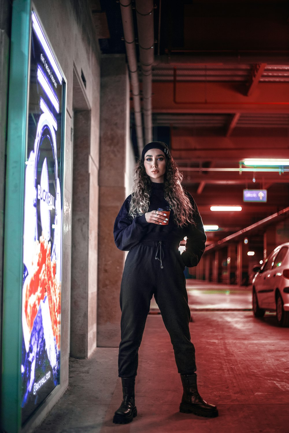 a woman is standing in a parking garage