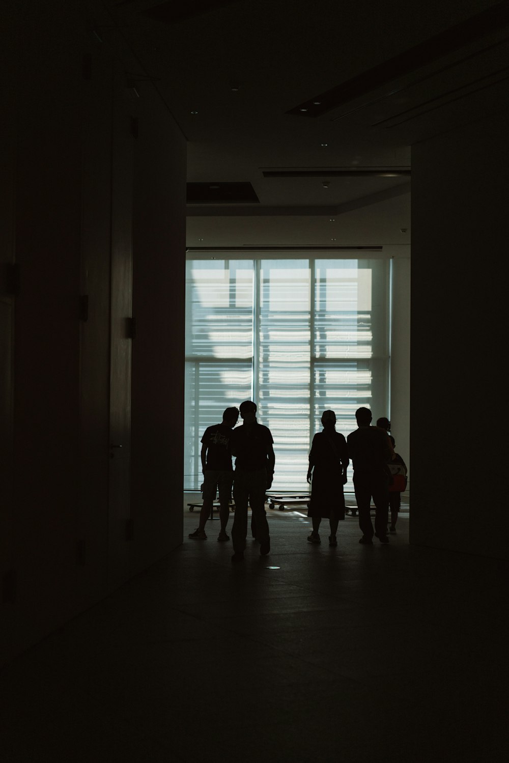 a group of people standing in front of a window