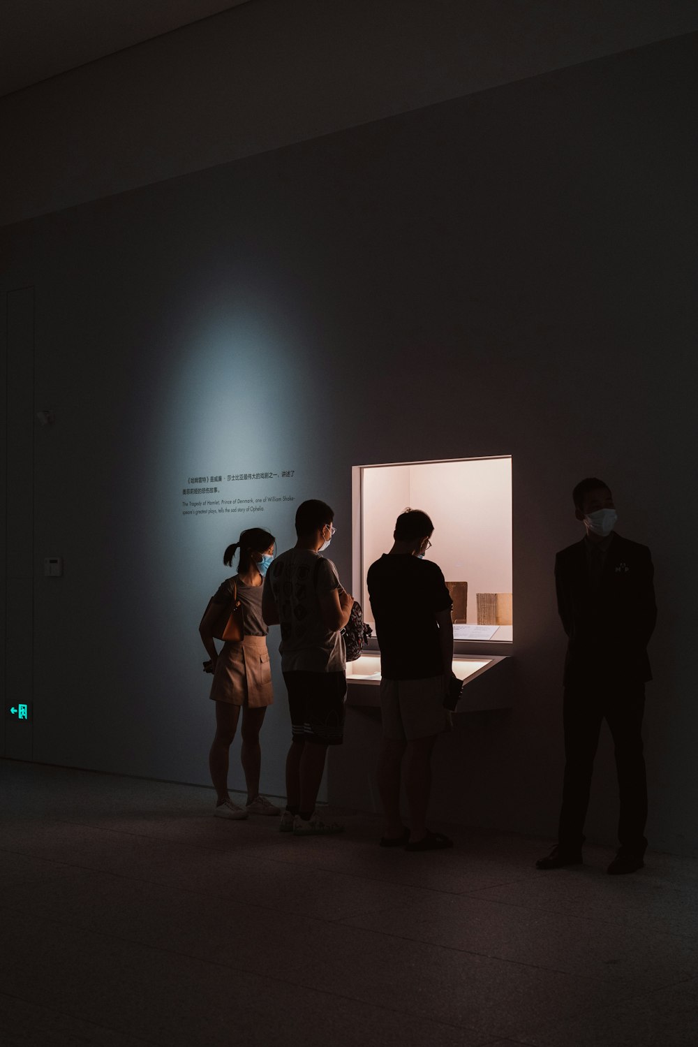 a group of people standing in a dark room