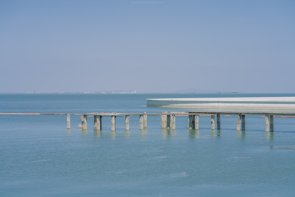 a large body of water sitting under a blue sky