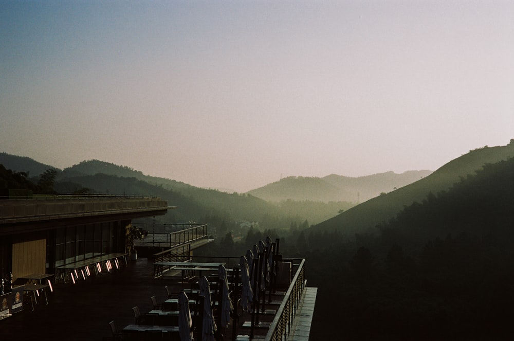 a view of a mountain range with a restaurant in the foreground