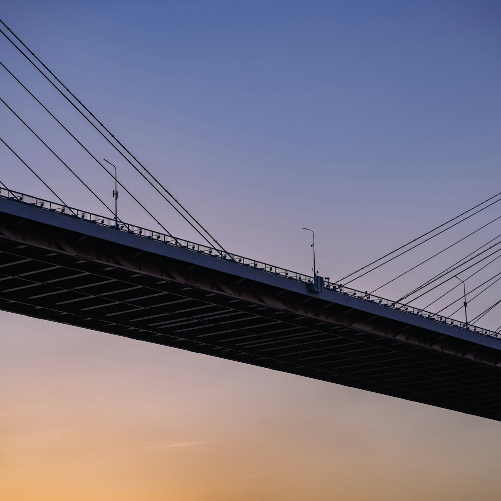 a bridge that has a plane flying over it