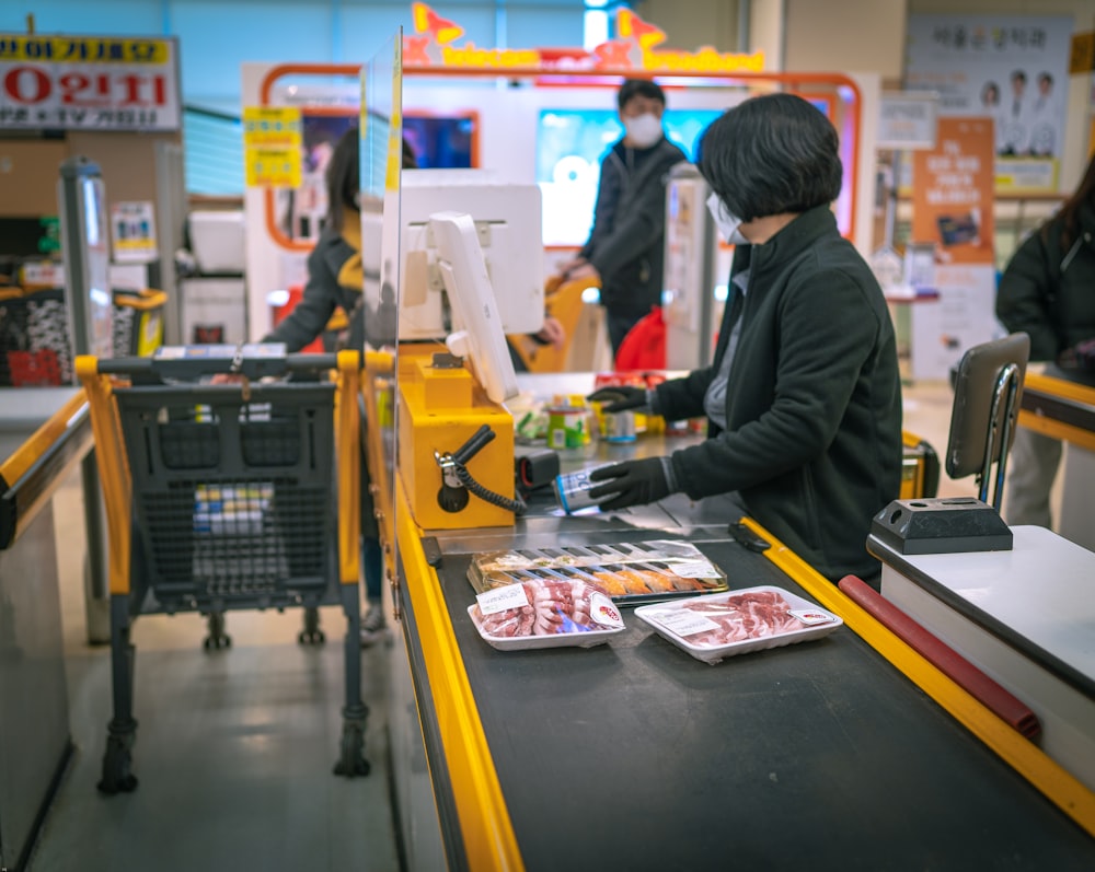 a woman standing at a cash register in a store