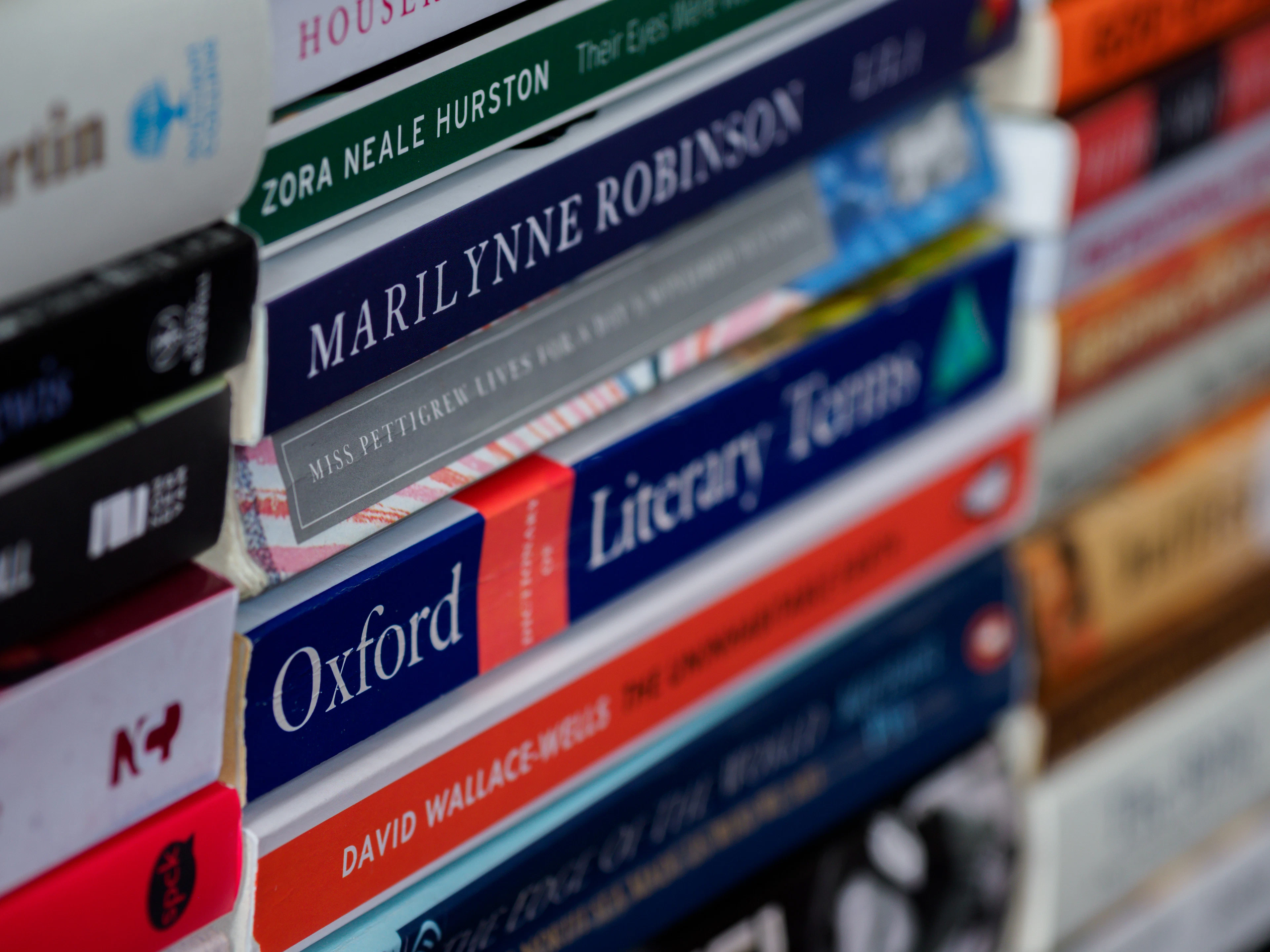 A stack of physical books showing the stock an author must plan to sell