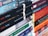 A collection of various books stacked horizontally and vertically. The spines show a range of titles and authors, with some books belonging to the Penguin Classics series. The books are stacked neatly, suggesting a well-organized library or personal collection.