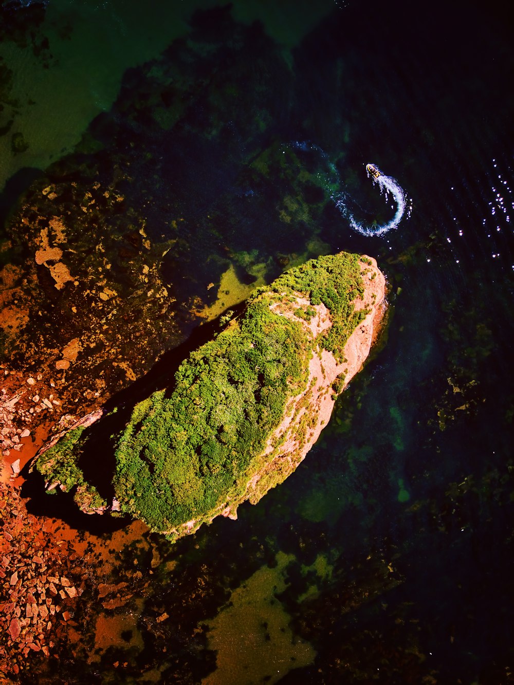 an aerial view of a rock formation in the water