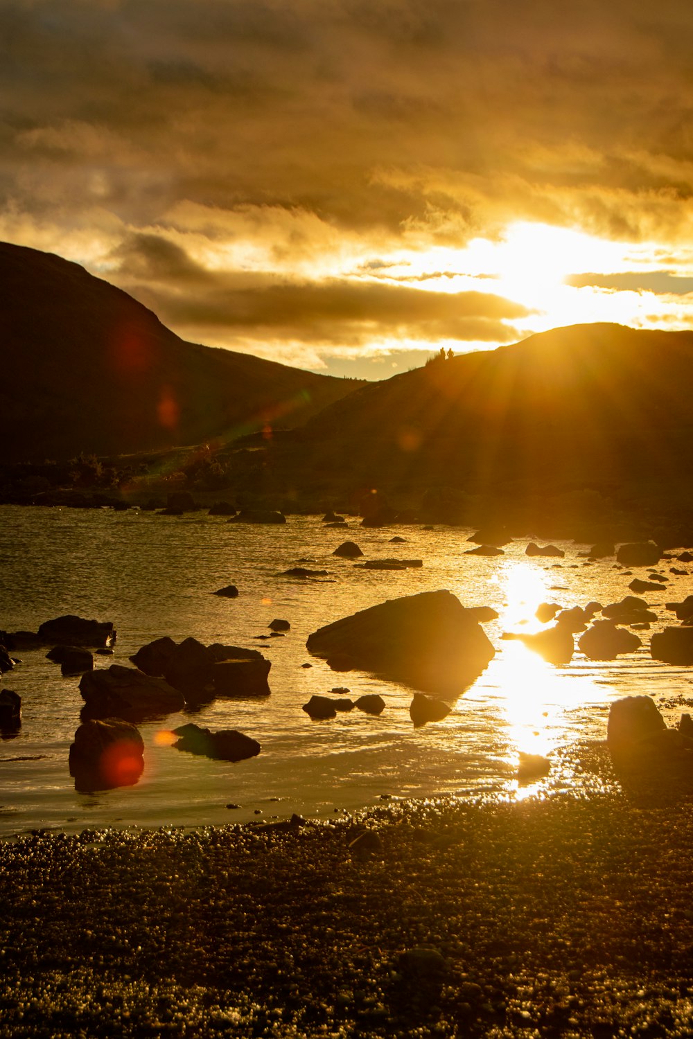 the sun is setting over a body of water