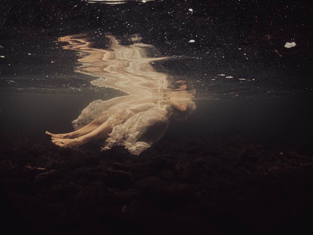 a woman floating in the water under water