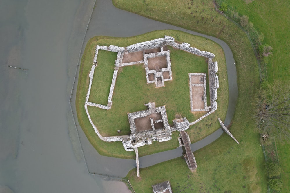 an aerial view of a castle in the middle of a body of water