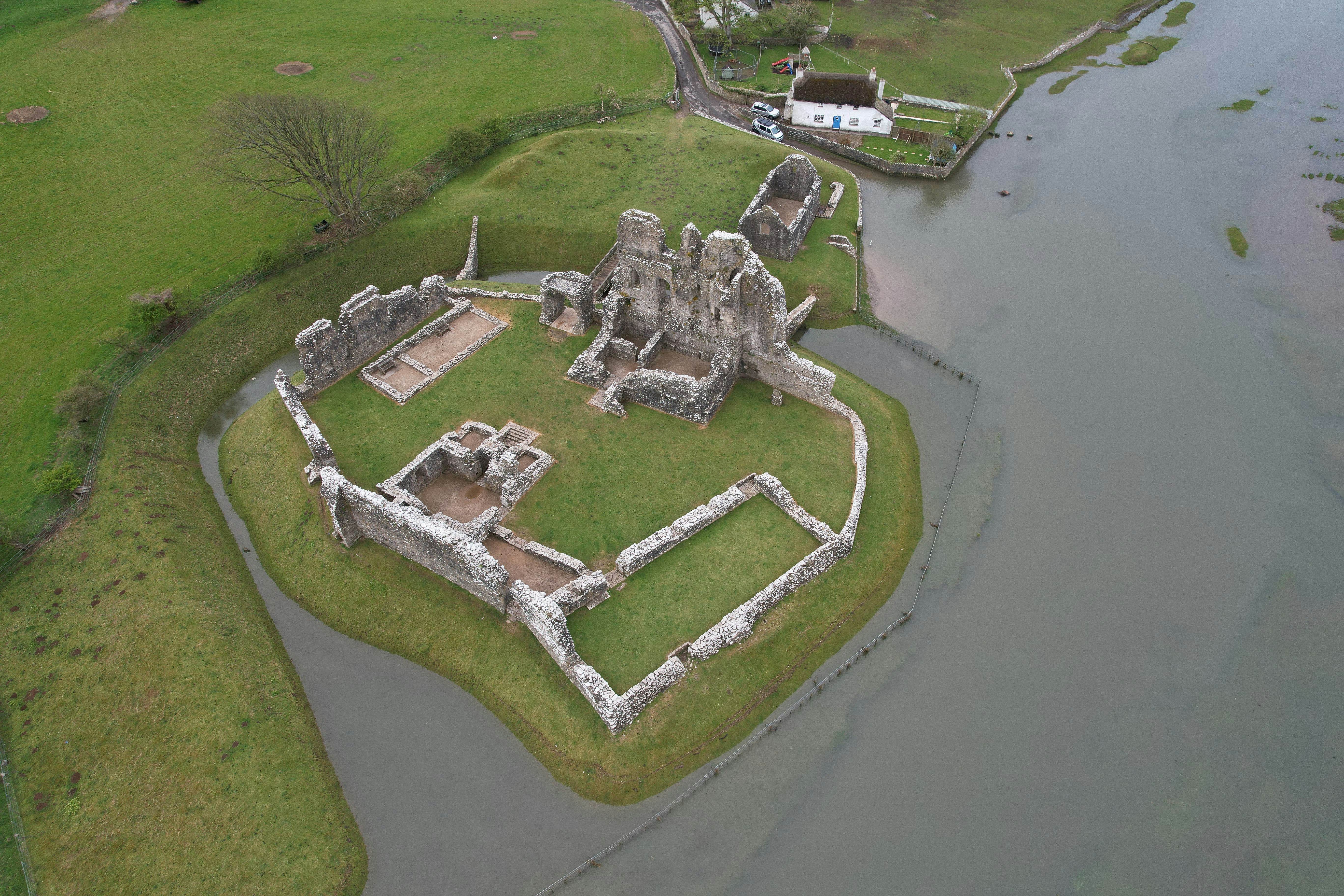 an aerial view of a castle in the middle of a river