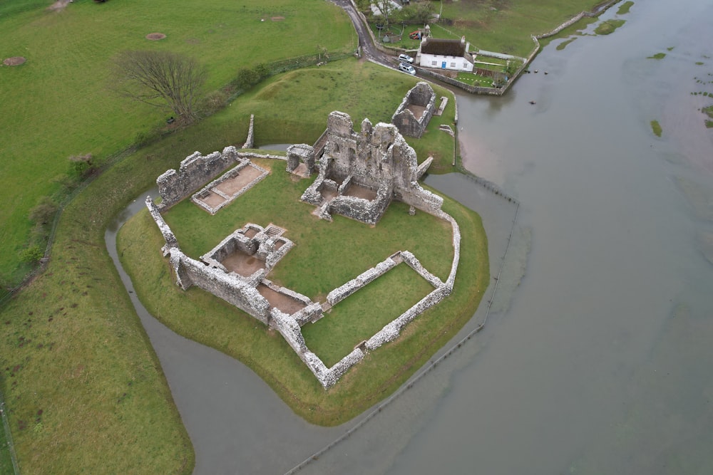 an aerial view of a castle in the middle of a river