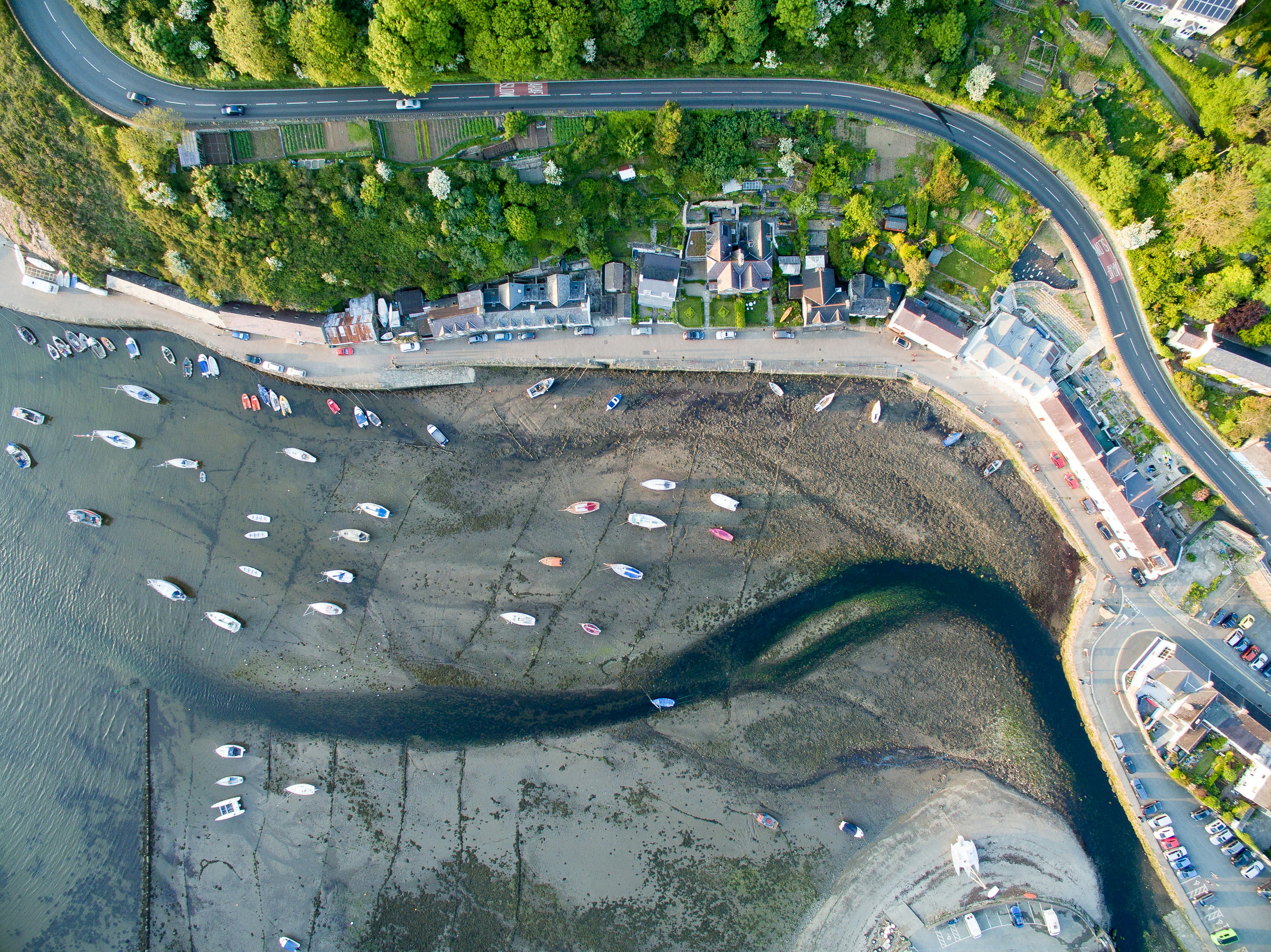 a bird's eye view of a parking lot next to a body of water