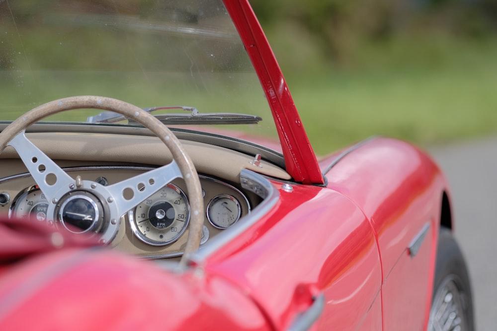 a red sports car with a steering wheel