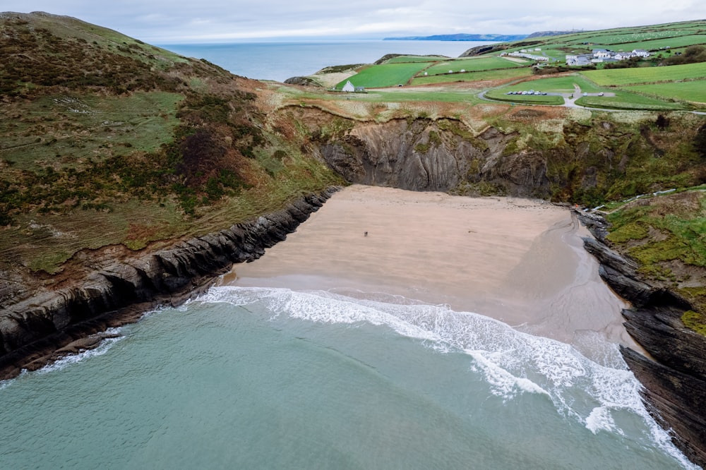 an aerial view of a sandy beach and a body of water