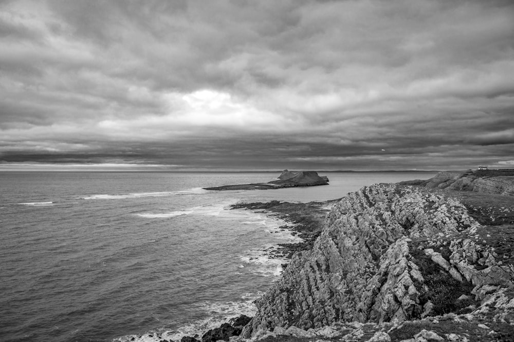 a black and white photo of a rocky coastline