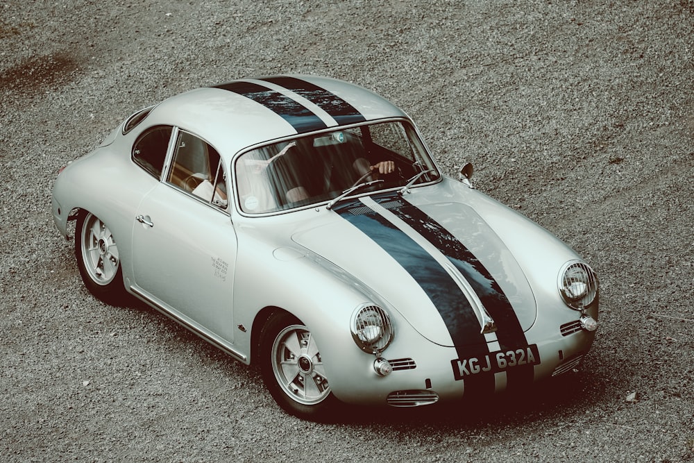 a silver car with a black and white stripe on it