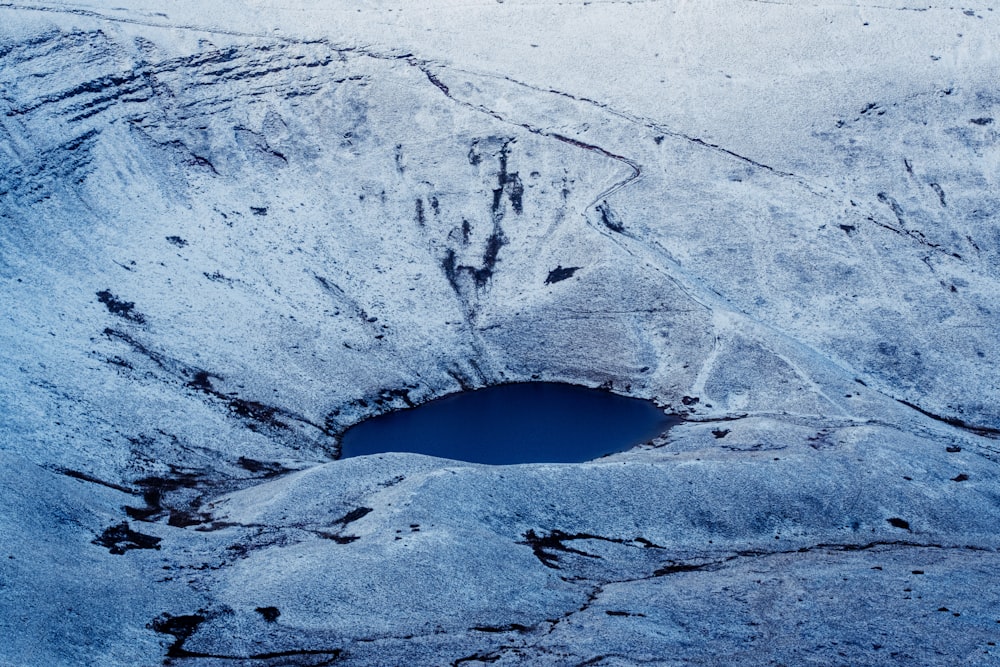 a snow covered mountain with a hole in the middle