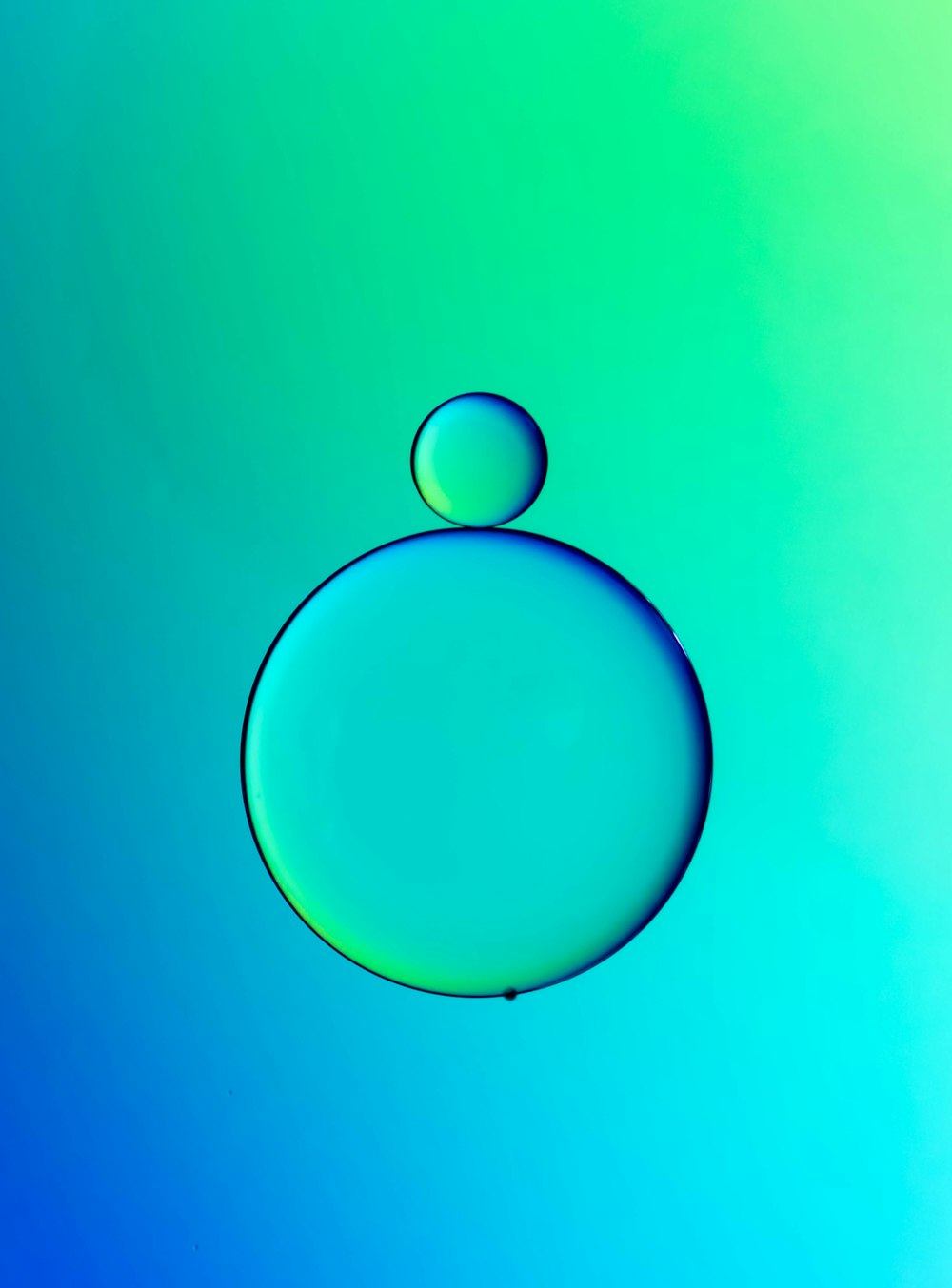 a drop of water with a blue and green background