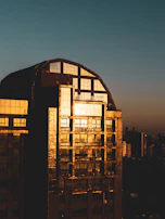 Sunset view of a finished bank building glowing warmly in the evening light.