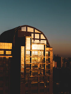 Sunset view of a finished bank building glowing warmly in the evening light.