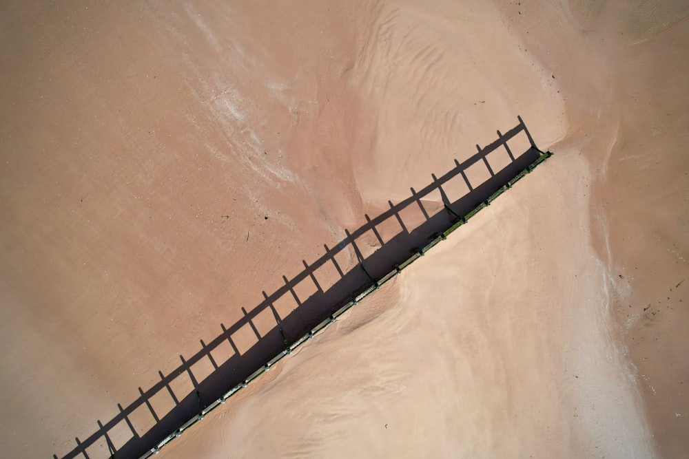 an aerial view of a beach with a fence