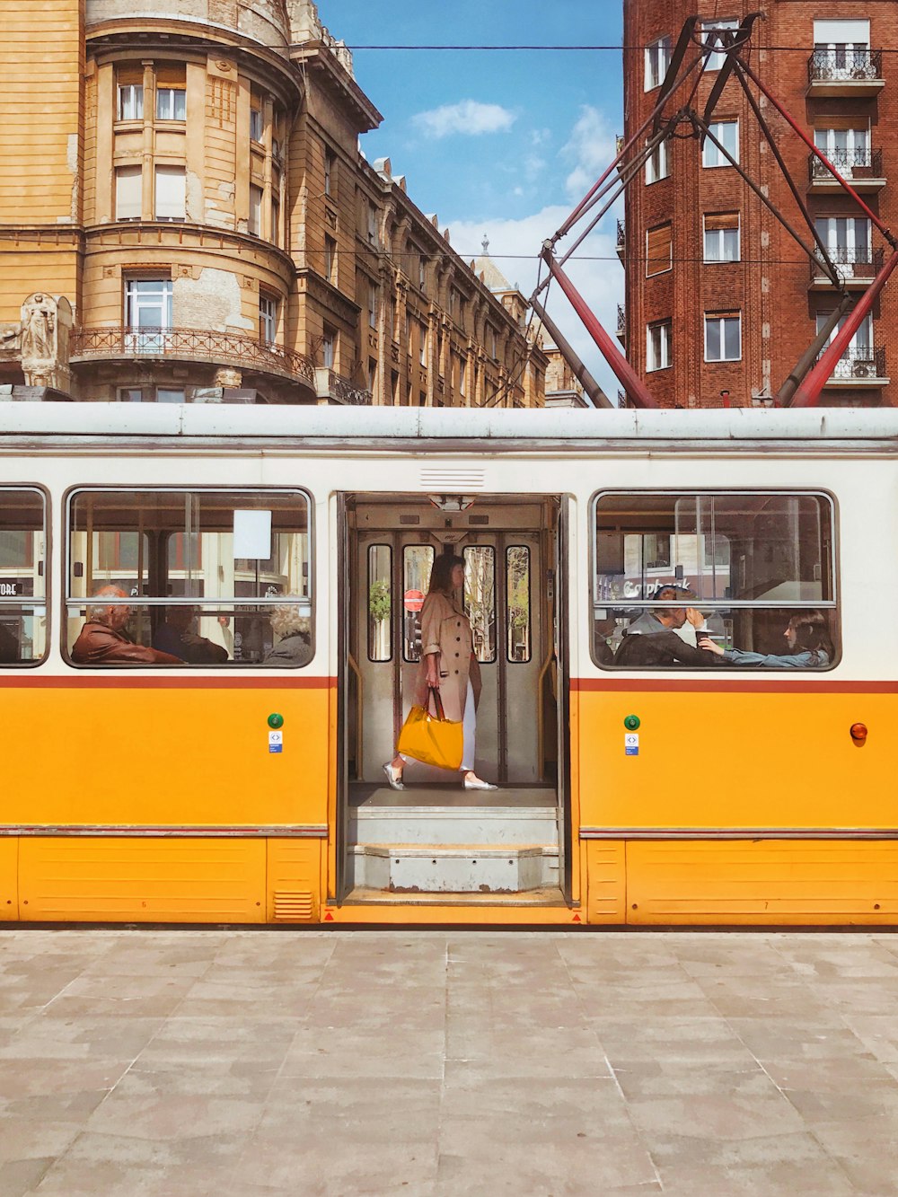 a yellow and white bus with its doors open