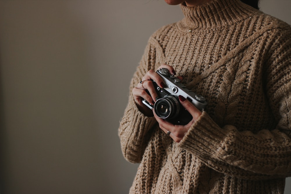 a woman holding a camera in her hands