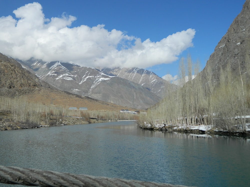 a body of water with mountains in the background