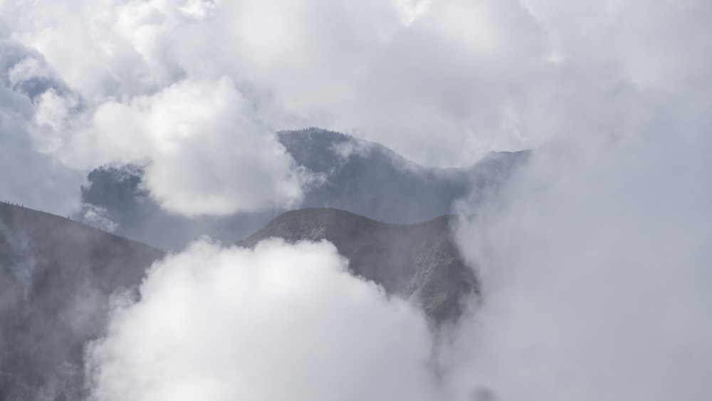 a view of a mountain covered in clouds