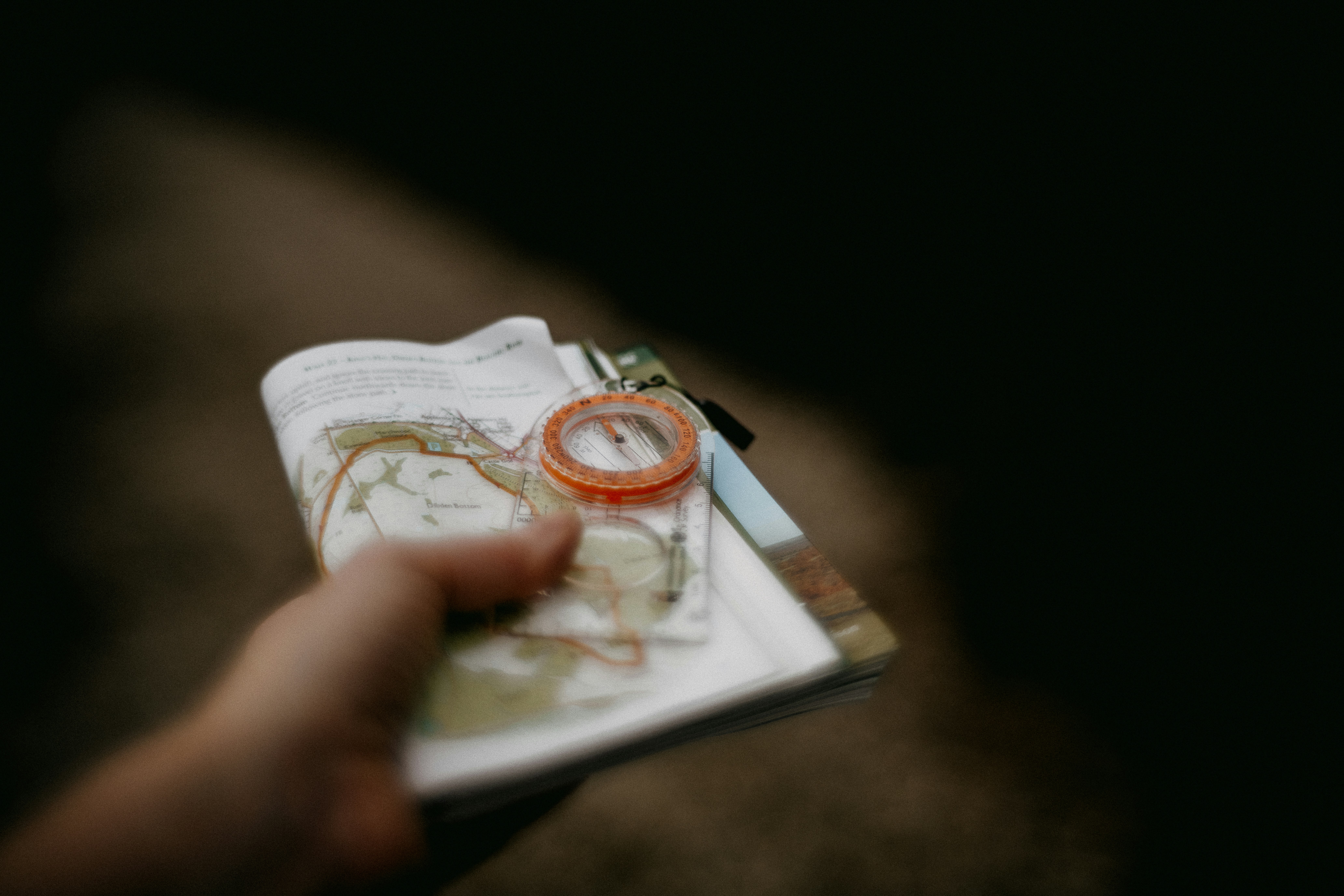 person examining a specimen with a hand lens magnifier outdoors