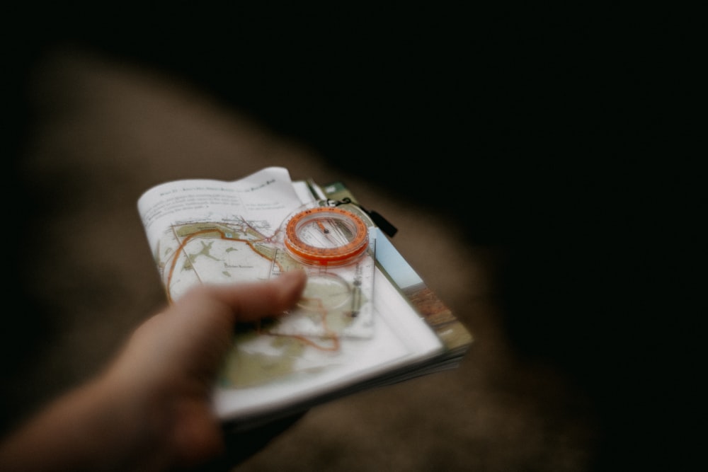 a person holding a book with a ring on it