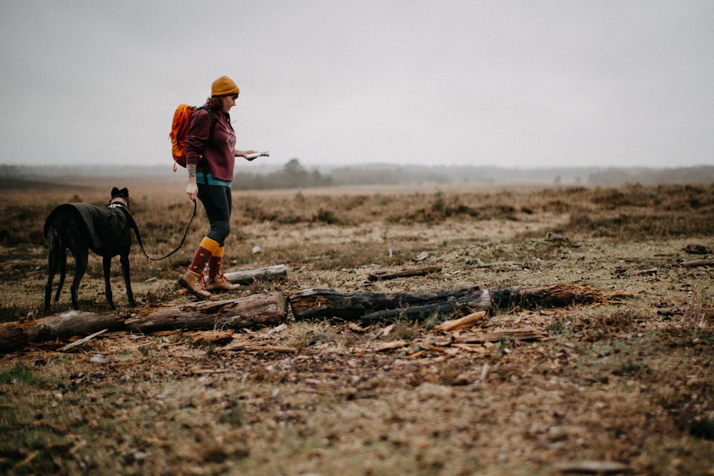 a person with a dog in a field