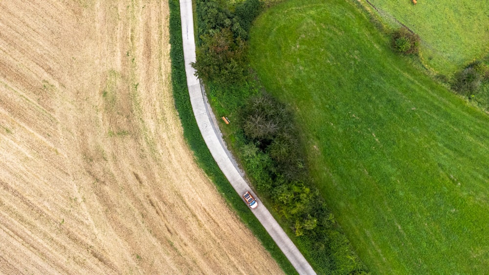 an aerial view of a road running through a field