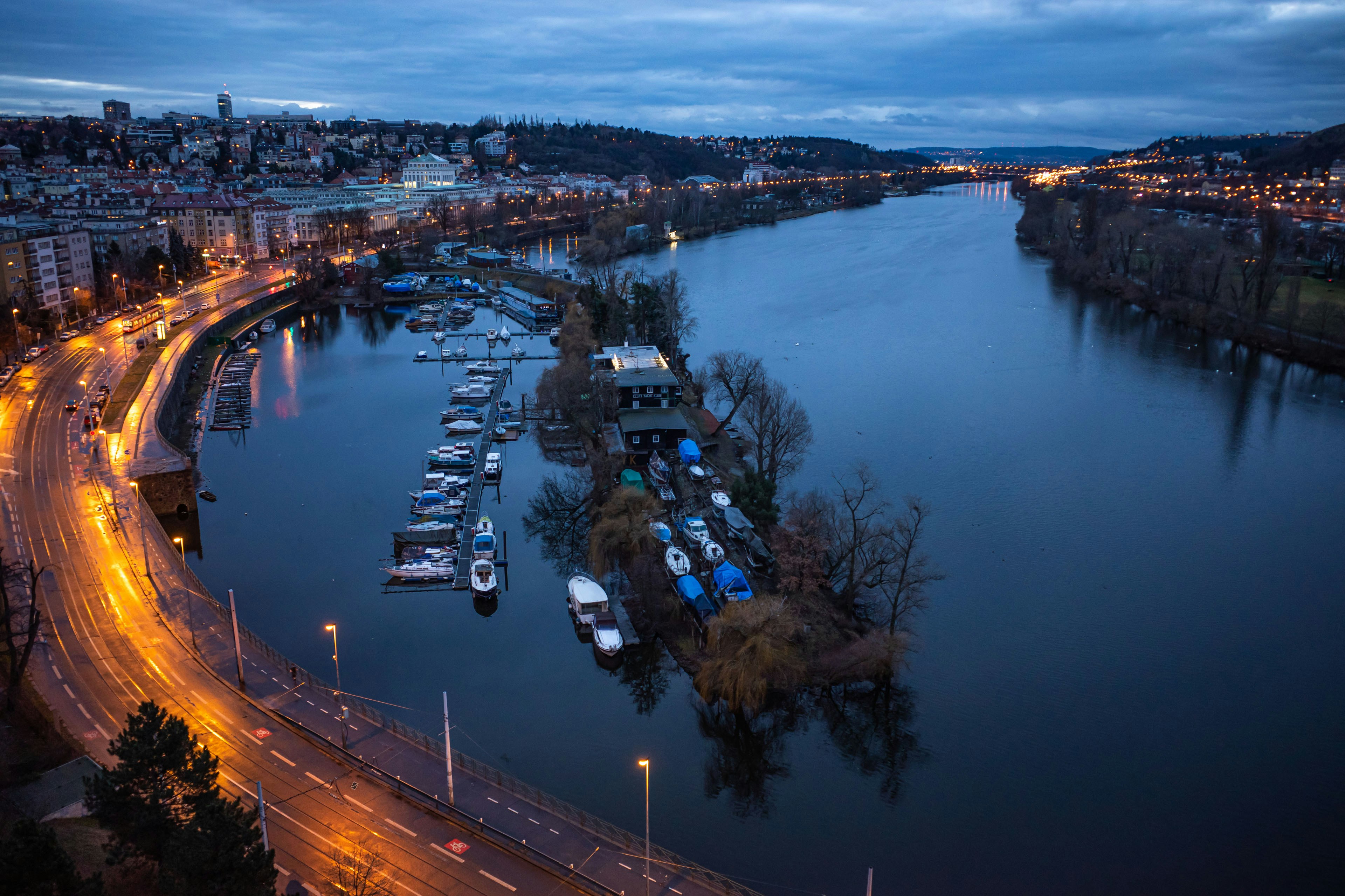 a harbor filled with lots of boats next to a city