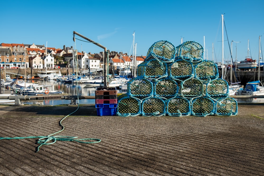 a pile of fishing nets sitting on top of a sandy beach