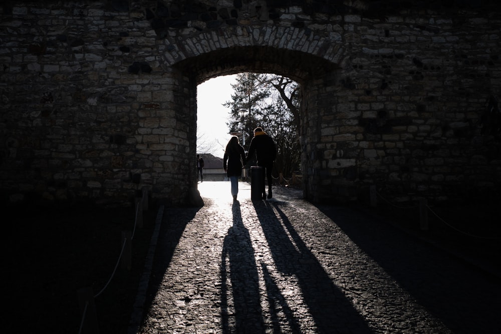 a group of people walking through a tunnel