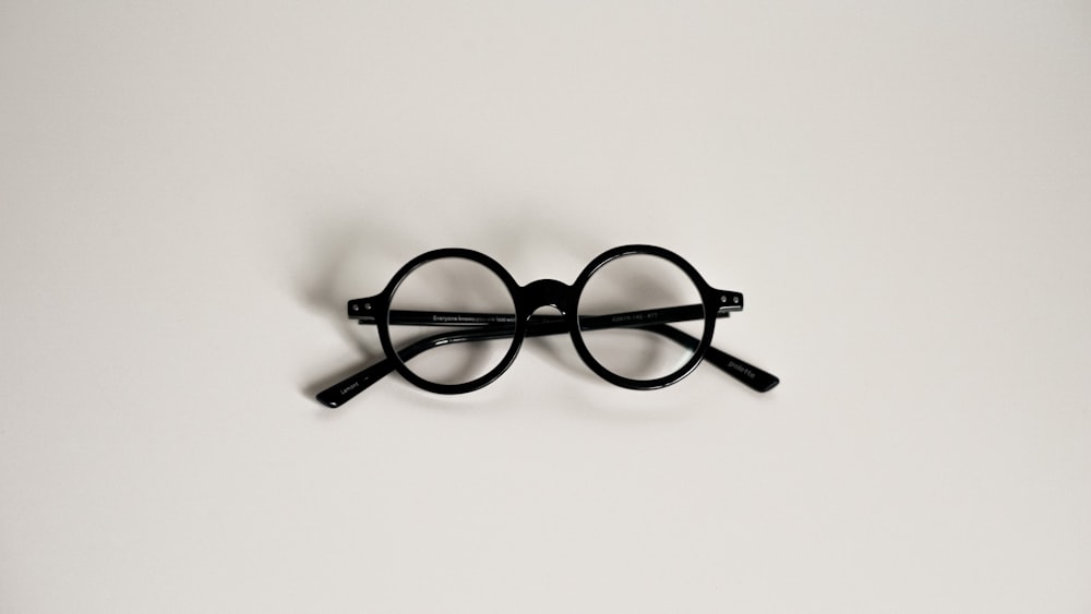 a pair of glasses sitting on top of a table