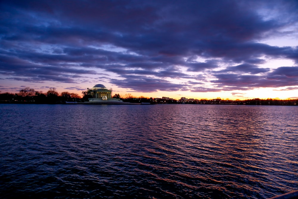 a large body of water under a cloudy sky