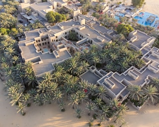 a bird's - eye view of a beach resort surrounded by palm trees proposed in Ghana by luxury builders
