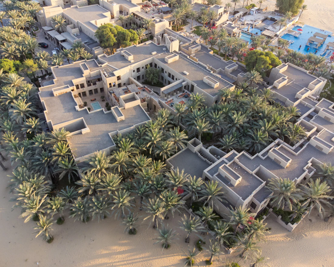 Aerial view of a beachfront community lined with palm trees