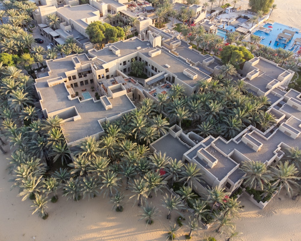 a bird's - eye view of a beach resort surrounded by palm trees
