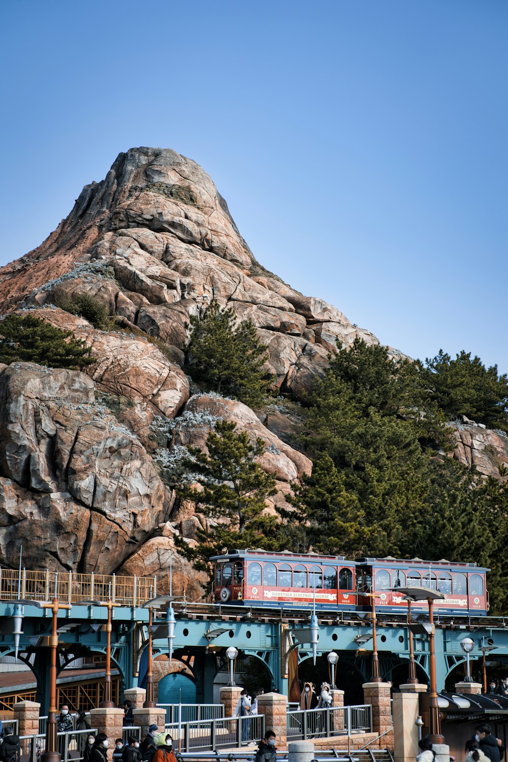 a train on a track near a mountain
