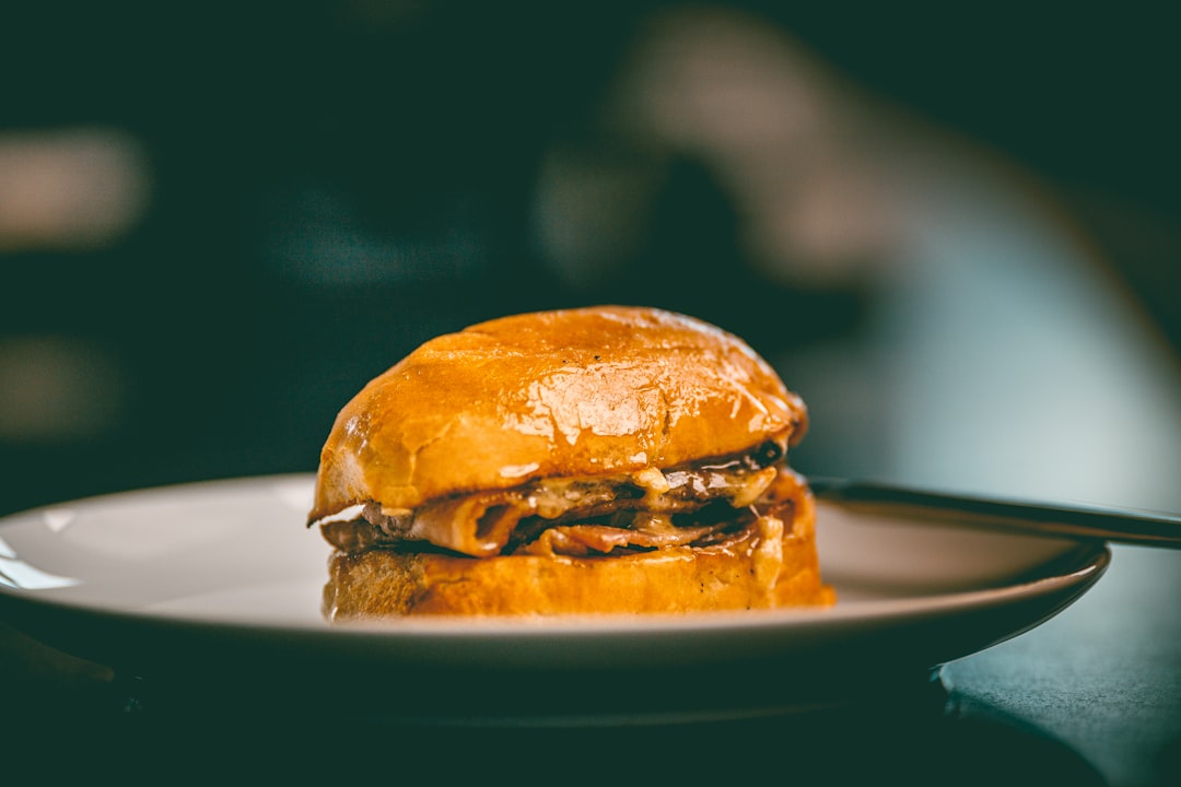 a sandwich sitting on top of a white plate, That sandwich. Landscape framing this time. Still mindblowing.