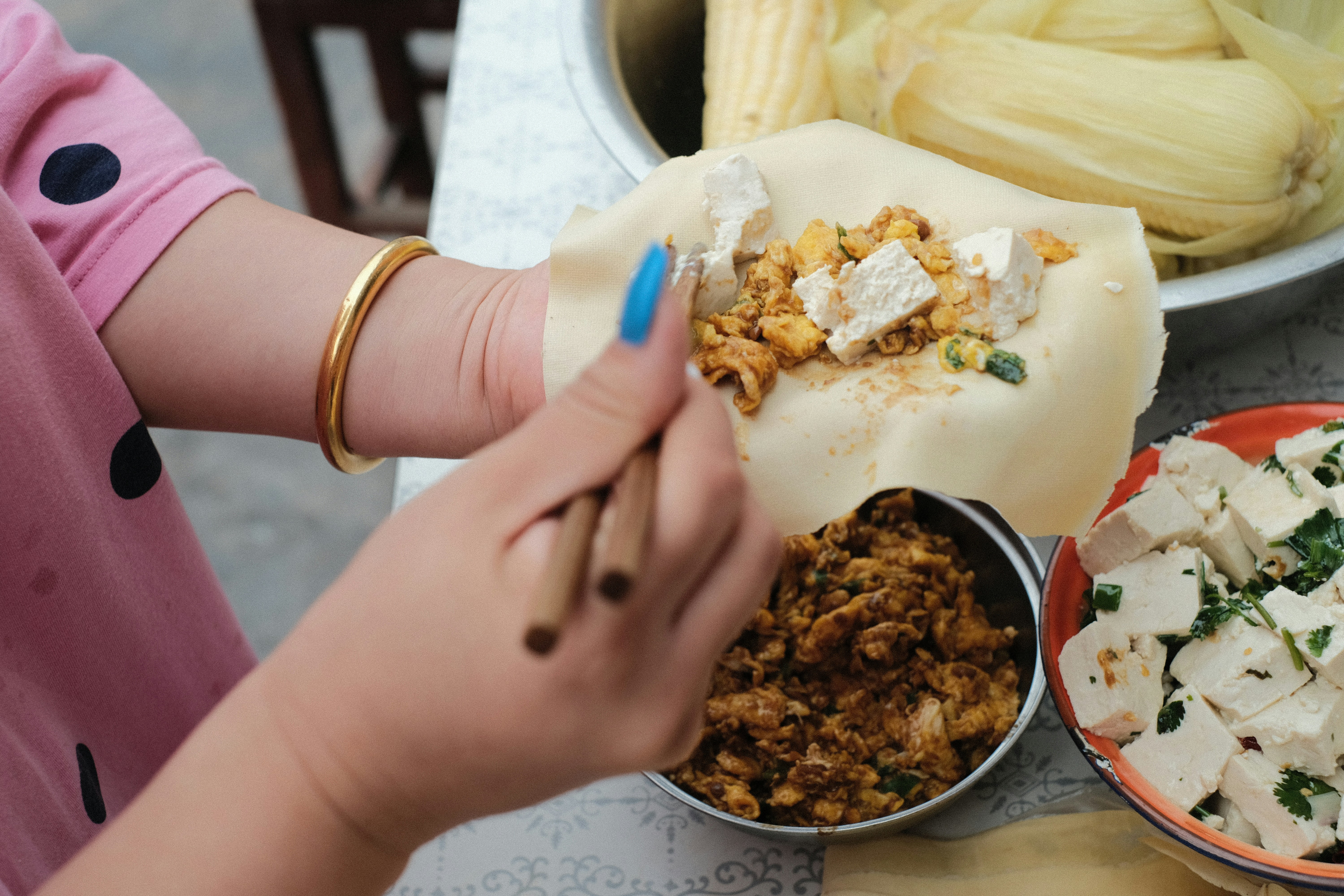 a woman is preparing food on a table