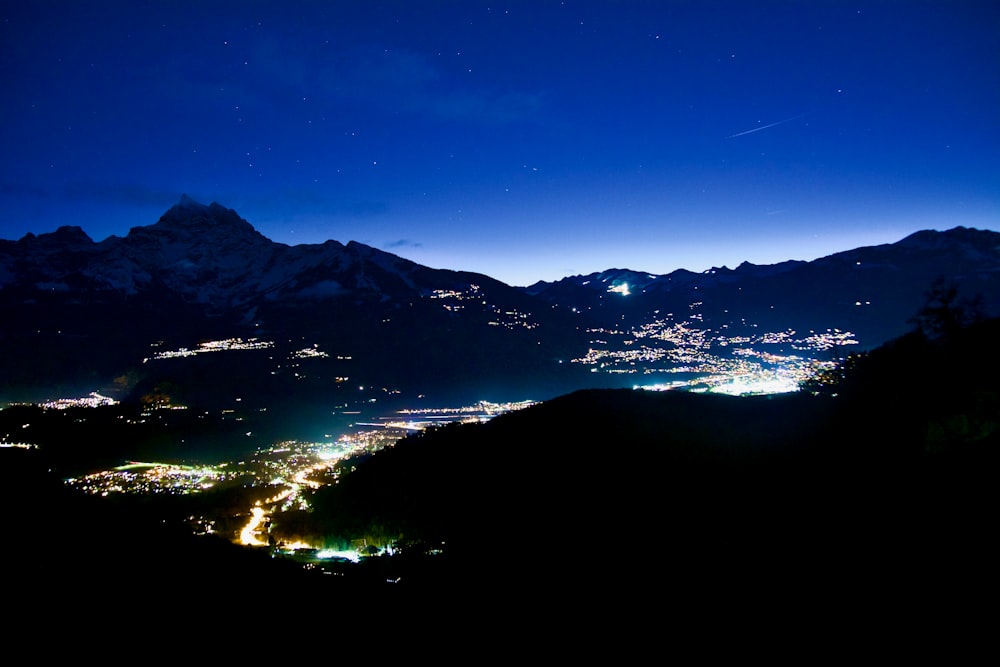 a night view of a town and mountains