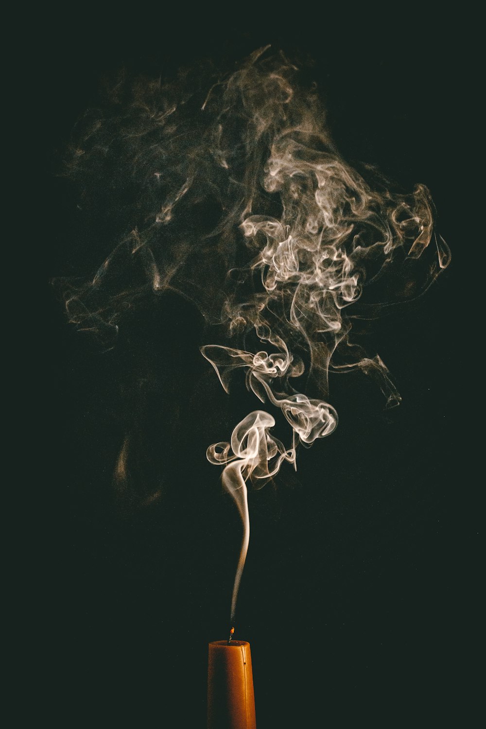 a cup filled with smoke sitting on top of a table